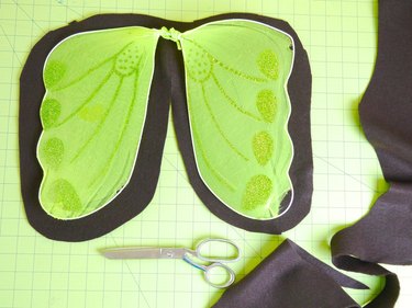 Wings on top of brown felt, cut 1-inch larger.