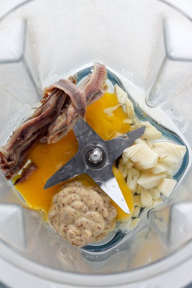 Combining the ingredients to create a paste.