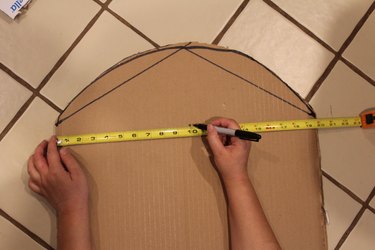 measuring the size of the tombstone with a tape measure