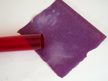 A piece of sand paper and the rough end of a tube.
