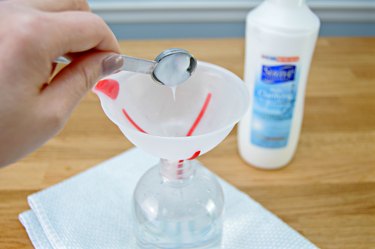 Adding cleaning solution to spray bottle