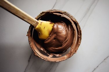 Use the rubber spatula to mix the food dyes together to form a rich brown color.