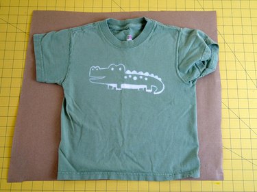 A T-shirt flat on a piece of brown paper.