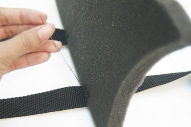 Sewing a foam shark fin to cloth belts for dressing up