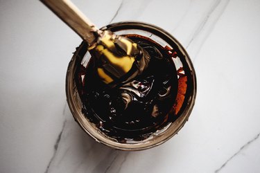 Use the rubber spatula to mix the dyes into the base until they are evenly distributed.