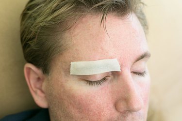 Cover your eyebrow as step 1 for this DIY project.