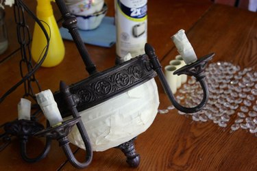 Cover the portions of the chandelier that do not need to be painted with tape.