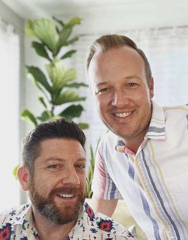 The Craft Grooms posing in their home during a rare moment of rest