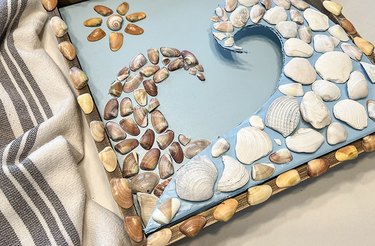 Shells lined up along the edge of the outer frame of the artwork