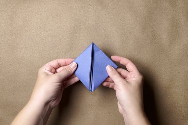 A folded diamond of blue construction paper