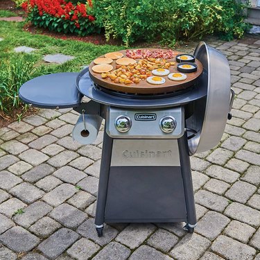 Cuisinart CGG-888 360° Griddle Cooking Center on a patio being used to cook breakfast foods.