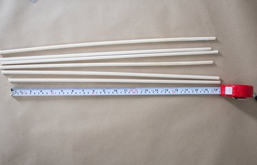 Several cut dowels next to a tape measure