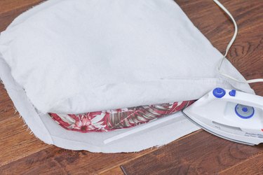 Ironing adhesive strips onto the sides of the cushions