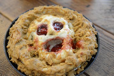 Mashed pumpkin pie with a scary dough center as a face