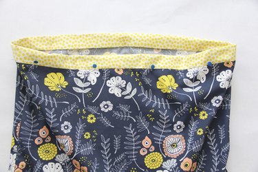 Fold waistband towards inside, pin and sew.