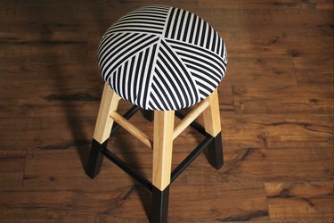 Upholstered and painted stool.