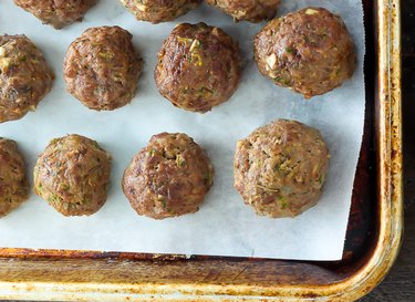 Cooked meatballs coming out of the oven.