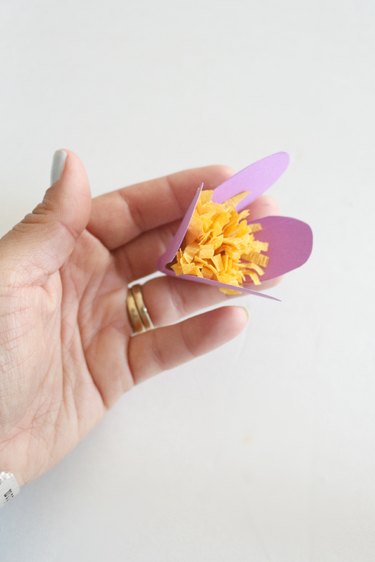Add glue and secure to middle of flower.