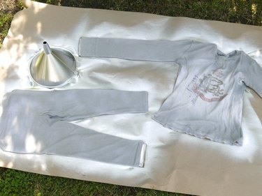 Clothing and funnel sprayed with silver paint.