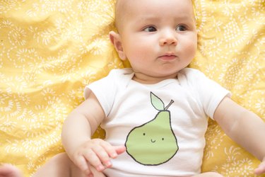 Baby wearing screen printed onesie