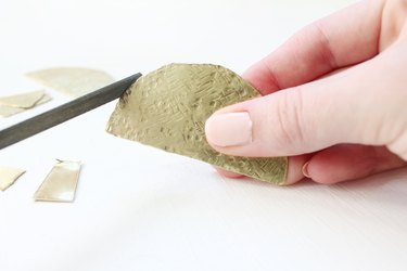 File down rough edges with a metal file