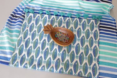 pinning the hand towel to the beach towel
