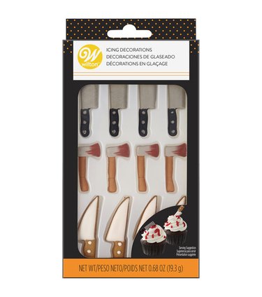 Small icing decorations in the shape of cleavers, bloody axes, and chef's knives.