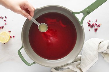 Heating rose water, sugar, pectin and lemon juice