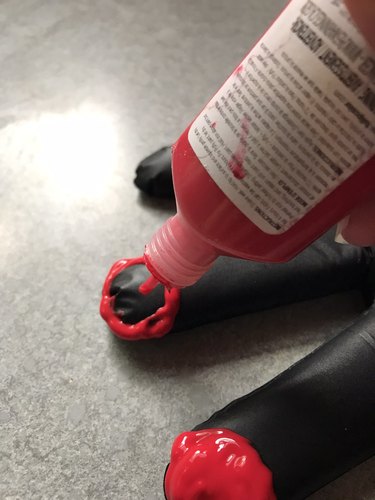 Make fake hands by decorating latex gloves filled with sand