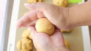 Rolling dough into a ball in palm of hands