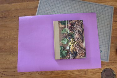 book sitting on purple wrapping paper