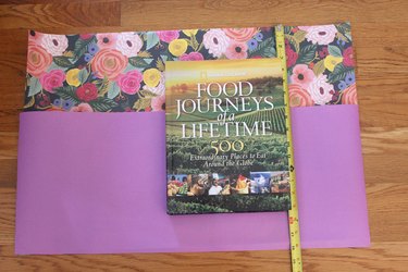 book sitting on second tier of paper
