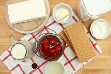 ingredients for cherry cheesecake jars laid out on table