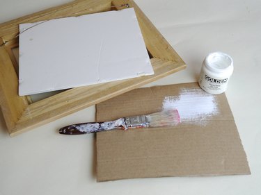 White frame backing and a sized cardboard piece painted white.