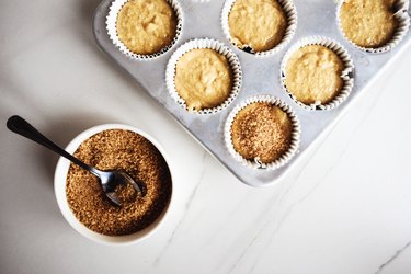 Sprinkle about a teaspoon of raw sugar on top of each muffin.