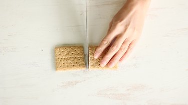 Slicing graham cracker in half