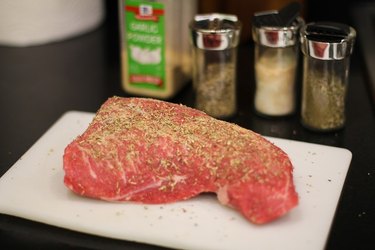 Tri-tip on a cutting board with seasoning
