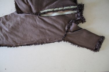 Backstitch where the jumsuit and sleeve meet at the armhole to add extra strength in the seam.