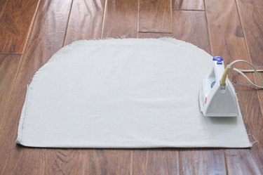 Ironing the adhesive strips to bond the fabric together