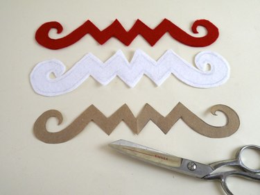 The designs cut out of red and white felt.