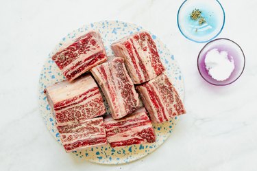 seasoning short ribs with salt and pepper