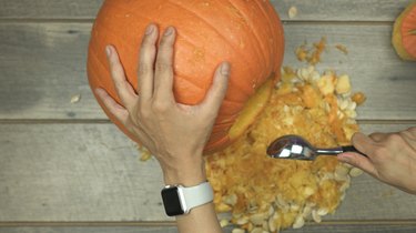 Scoop out pumpkin to make DIY pumpkin keg