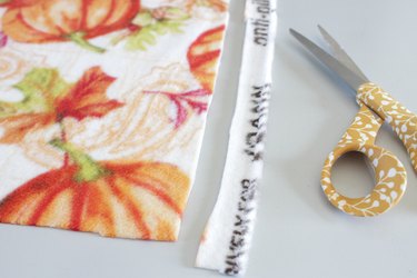 Cut the edges on a DIY braided fleece blanket
