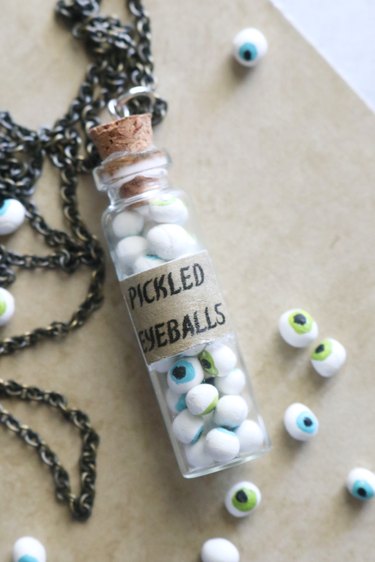 Completed glass bottle necklace filled with clay eyeballs