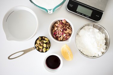 Small containers with individual ingredients next to a scale.