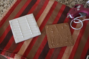 Applying hot glue to the cork coaster