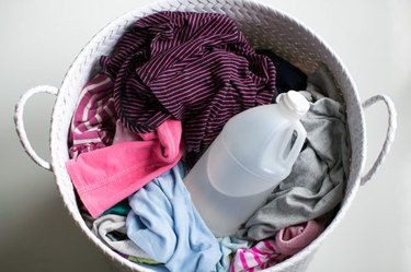 Basket of laundry and bottle of vinegar