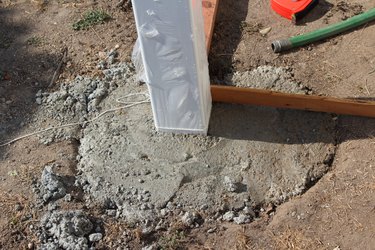 fence post anchored with concrete