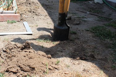 Using a post hole digger for posts.