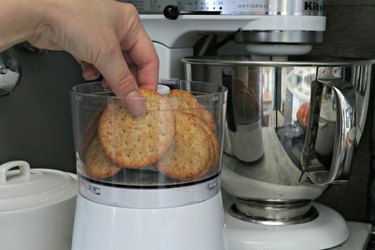 Placing crackers in a food processor